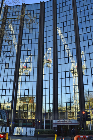 London, Great Britain - January 15th 2016: Building in Southwark with reflection of cranes in glass facadeのeditorial素材