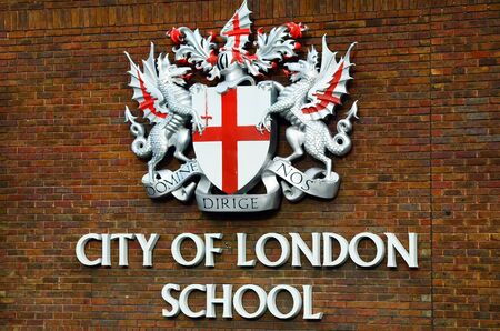London, United Kingdom - January 17th 2016: Brick wall with emblem of City of London Schoolのeditorial素材
