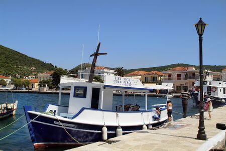 Vathi, Greece - May 23rd 2006: Unidentified people and excursion boats in the harbor of ithaca island in Ionean seaのeditorial素材