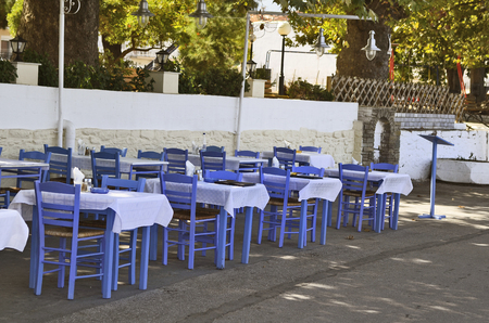 Greece, restaurant with blue tables and chairs in Thassosの写真素材