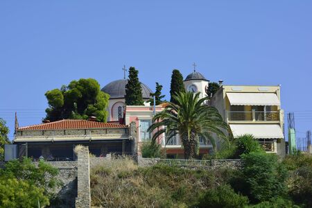 Kavala, Greece - September 18th 2015: Unidentified people on terrasse of a restaurant and byzantine church Theotokuのeditorial素材