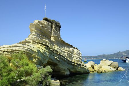Greece, Zakynthos Island, rock with Greek flag in Agios Sostisの写真素材