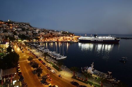 Kavala, Greece - illuminated city with fortress, harbor and car ferryのeditorial素材