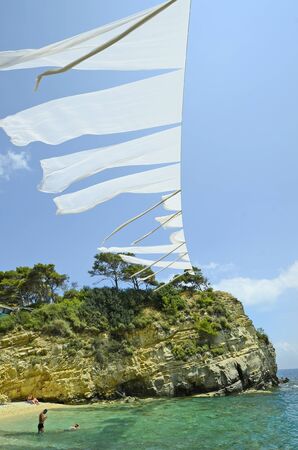 Zakynthos, Greece - May 24th 2016: Unidentified people on beach of tiny cameo in Iceland Ionian sea, preferred tourist attraction near Laganasのeditorial素材