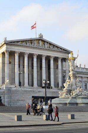 Vienna, Austria - November 29th 2011: Unidentified people in front of Austrian Parliament building on Ringstrasse with statue of Pallas Atheneのeditorial素材