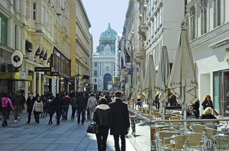 Vienna, Austria - March 27th 2016: Crowd of unidentified people on Kohlmark with Hofburg in the inner cityのeditorial素材