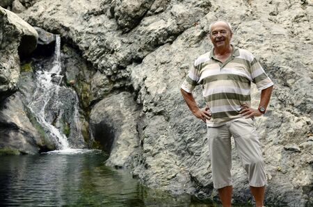 Greece, Samothrace, man in front of natural pool and small waterfall Gria-Vathraの写真素材