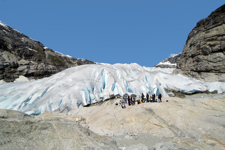 Jostedalen, Norway - June 13, 2009: Group of unidentified tourists on glacier tongue of Nigardsbreen...