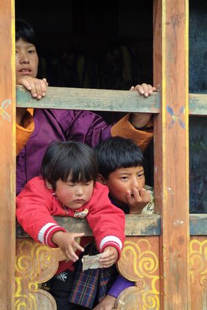 Haa, Bhutan - September 20, 2007: Unidentified spectators, woman with children by religious festivity named Tshechu in Karpho temple in Haa village,のeditorial素材