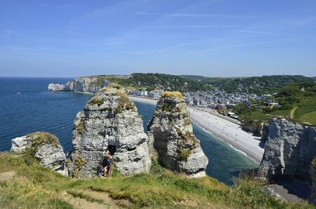 Etretat, France - June 02, 2011: Unidentified people on rock hole with view to beach of sea ressort on Englsh Channel coast in Normandy Etretat, France - June 02, 2011: Unidentified people on rock hole with view to beach of sea ressort on Englsh Channel coast in Normandy