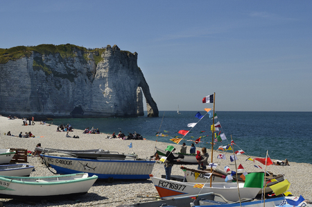 Etretat, France - June 02, 2011: Unidentified people and boats on beach of the  sea ressort on Englsh Channel coast in Normandyのeditorial素材