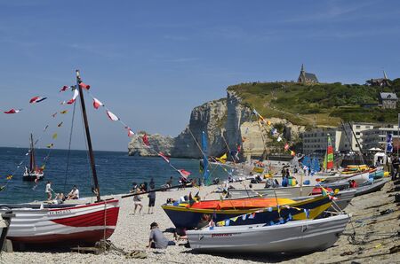 Etretat, France - June 02, 2011: Unidentified people and boats on beach of the  sea ressort on Englsh Channel coast in Normandyのeditorial素材
