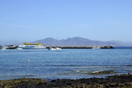 Corralejo, Fuerteventura, Spain - March 29, 2017: Harbor with ferry and Lanzarote Island in backgroundのeditorial素材