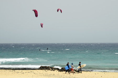 Fuerteventura, Spain - March 31, 2017: Unidentified sporty people on beach on Canary island, preferred destination for surfer and kiterのeditorial素材