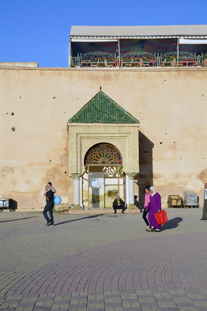 Meknes, Morocco - November 19th 2014: Unidentified people on place el-Hedim in front of the medieval city wall with covered restaurant aboveのeditorial素材