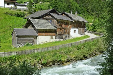 Ritzenried, Austria - June 20, 2017: Old farmstead and stream in Pitztal valley in North Tyrolのeditorial素材