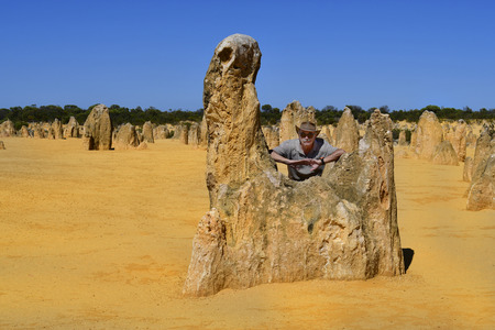 Cervantes, WA, Australia - November 23, 2017: Man on rock of The Pinnacles in Nambung National Park, preferred tourist attraction and natural landmarkのeditorial素材