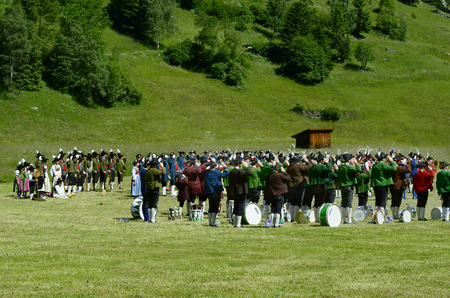 Feichten, Tyrol, Austria - June 22, 2014: Unidentified people in traditional outfit in Dirndl and Lederhose by field mass in Kaunertal valleyのeditorial素材