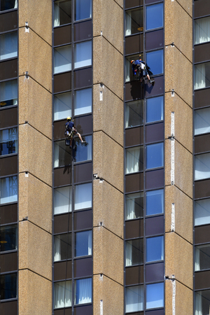 Australia, Sydney, two window cleaners working outside on office building facadeのeditorial素材