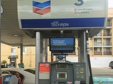 Los Angeles, CA, USA - May 31, 2018: Petrol station with advertisement for legal marijuana saleのeditorial素材