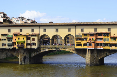 Florence, Italy - June 13, 2012: Medieval old bridge - Ponte Vecchio - a stone closed-spandrel segmental arch bridge over Arno River, one of the landmarks in the Unesco World Heritage site in Tuscanyのeditorial素材