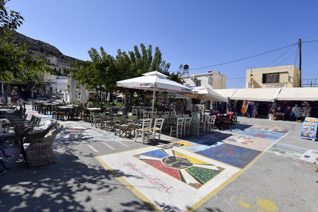 Matala, Greece - October 07, 2018: Unidentified people, different restaurants, shops and street paintings on main square in the town in the south of Creteのeditorial素材