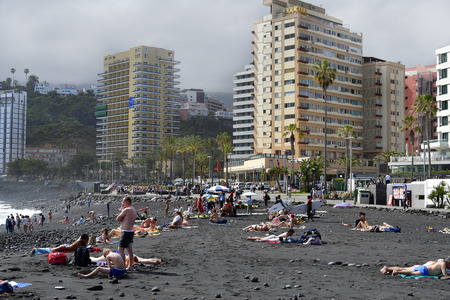 Tenerife, Canary Islands, Spain - April 01, 2018: Unidentified people on sandy beach in Puerto de la Cruzのeditorial素材