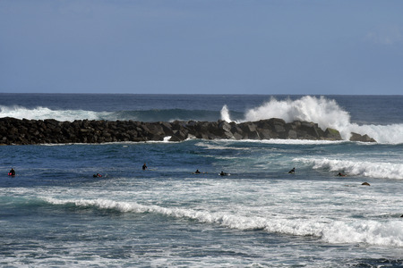 Tenerife, Canary Islands, Spain - April 01, 2018: Unidentified surfers and heavy waves on beach in Puerto de la Cruzのeditorial素材