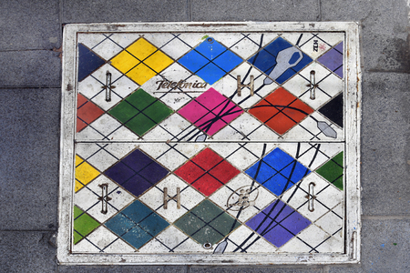 Tenerife, Canary Islands, Spain - April 03, 2018:  Painted manhole cover in a street of Puerto de la Cruzのeditorial素材