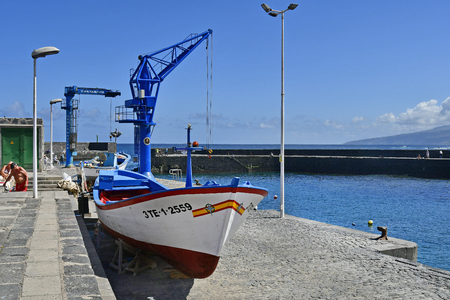 Tenerife, Canary Islands, Spain - April 03, 2018:  Unidentified people and cranes on tiny harbor at Playa del Muelle in Puerto de la Cruzのeditorial素材