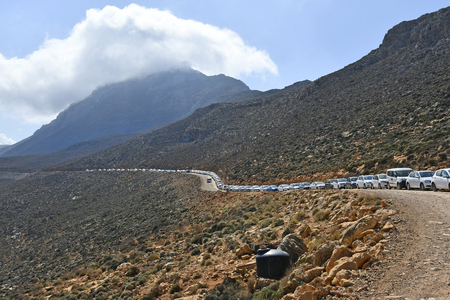 Greece, a line of traffic on gravel road to Balos Lagoon on Gramvousa peninsulaの写真素材