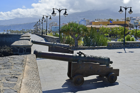 Spain, Canary Islands, Tenerife, old cannons in public Castillo San Felipe, a medieval fortress in Puerto de la Cruzの写真素材