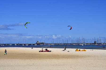 Melbourne, VIC, Australia - November 04, 2017: Unidentified people, kite surfer and sailing ships in...