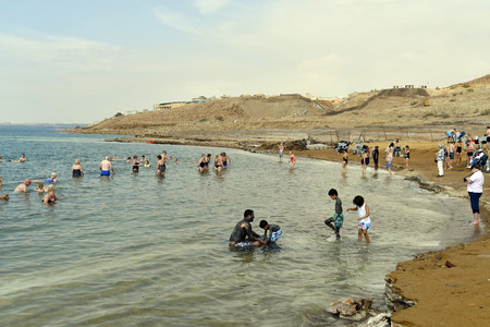 Dead Sea, Jordan - March 05, 2019: Unidentified people enjoy a swim in the salt lake, unsinkable for heavy salinity and mud used for medical treatmentのeditorial素材