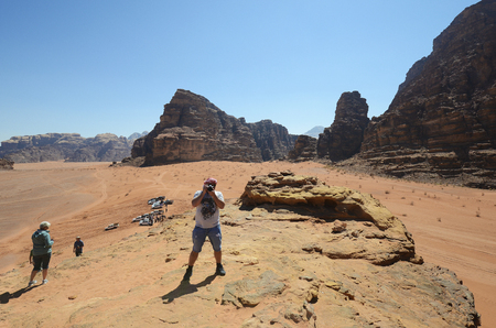Wadi Rum, Jordan - March 07, 2019: Unidentified tourists climb to top of the big sand dune in the UNESCO World heritage site in Middle Eastのeditorial素材