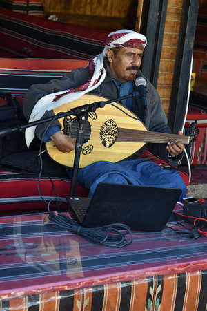 Wadi Rum, Jordan - March 07, 2019: Unidentified musician play traditional string instrument named...