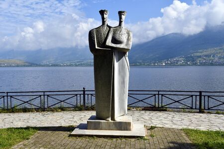 Ioannina, Greece - June 05, 2019: Statue named - Couple - from Greek sculptor Theodoros Papagianis on shore of lake Pamvodita aka lake Pamvotisのeditorial素材