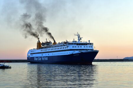 Kavala, Greece - September 27, 2019: Ferry with puff of smoke approaching the harbor of the city in Eastmacedonia on Aegean seaのeditorial素材