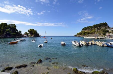 Parga, Greece - September 21, 2019: Ruin of medieval castle, boats and chapel on tiny island, located on Ionian sea, a preferred destination for vacation and holidayのeditorial素材
