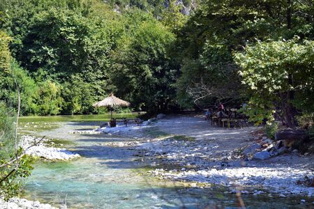 Glyki, Greece - September 21, 2019: Unidentified people relax on shore of Acheron river, a preferred...