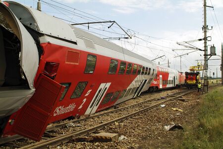 Gramatneusiedl, Austria - July 27, 2005: Unidentified workers by repair of power cables after train accident with wrecked wagonsのeditorial素材
