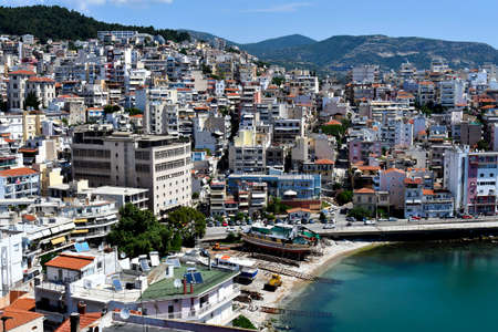 Kavala, Greece - June 13, 2019: Wharf and buildings in the city on Aegean sea