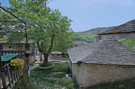 KALARITES, GREECE - JUNE 06, 2019: Homes covered with stone shingles and main square in mountain village an Aromanian village in National Park of Tzoumerka, no traffic is possible, no streets for cars or trucks;のeditorial素材