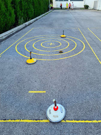 Reisenberg, Austria 10, 2020. Unidentified people by outdoor stick shooting on asphalt, kind of sport similar to curlingのeditorial素材