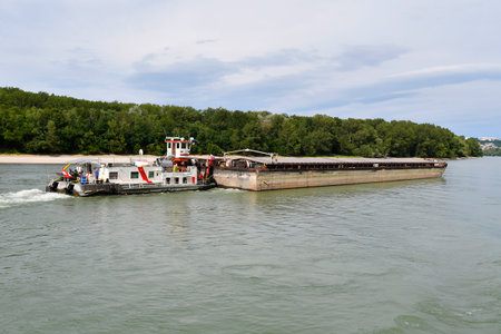 Bratislava, Slovakia - July 21, 2019: Unidentified man on board of the vessel for pushed-convoy ship on Danube river, a traditional river navigation and alternative freight transportのeditorial素材
