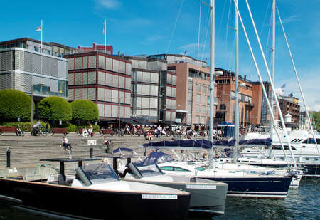 Oslo, Norway - June 21, 2009: Unidentified people enjoy a sunny day on promenade in Aker Brygge districtのeditorial素材
