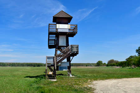 Andau, Austria - May 04, 2021: Observation tower at the rebuilt historical bridge of Andau, where the refugees from Hungary fled to Austria in 1956 from the Hungarian revolutuion, located in the national park Neusiedlersee-Seewinkelのeditorial素材