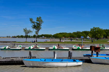 Podersdorf, Austria - May 029, 2021: Unidentified people and boats in the seaside resort on lake...