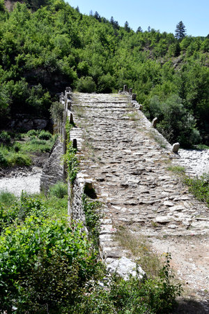 Greece, Epirus, medieval stone bridge of Plakidas over dry Voidomatis river