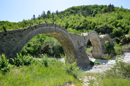 Greece, Epirus, medieval stone bridge of Plakidas over dry Voidomatis river
